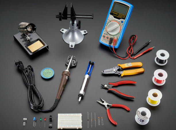Essential tools for PCB testing displayed on a workbench