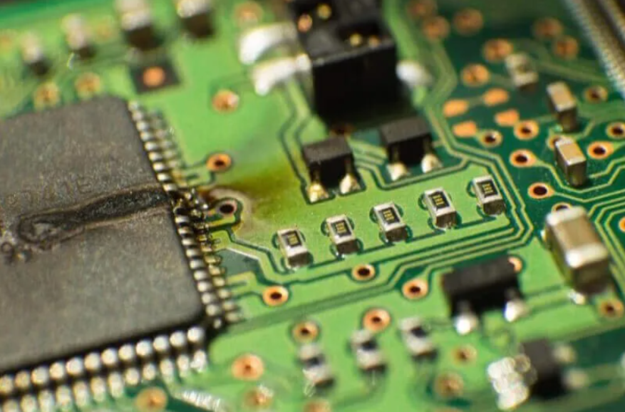 Short circuit on PCB due to component misplacement.