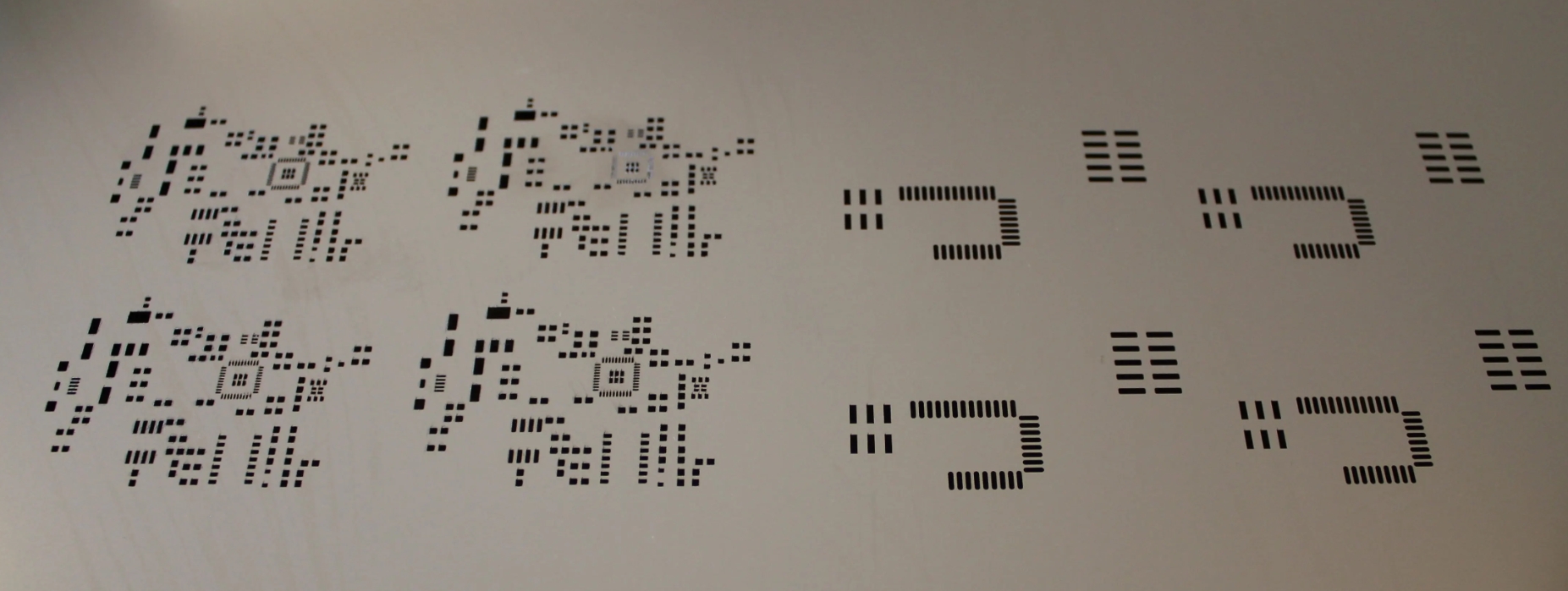 Solder paste stencil aligned on a PCB for precise application.
