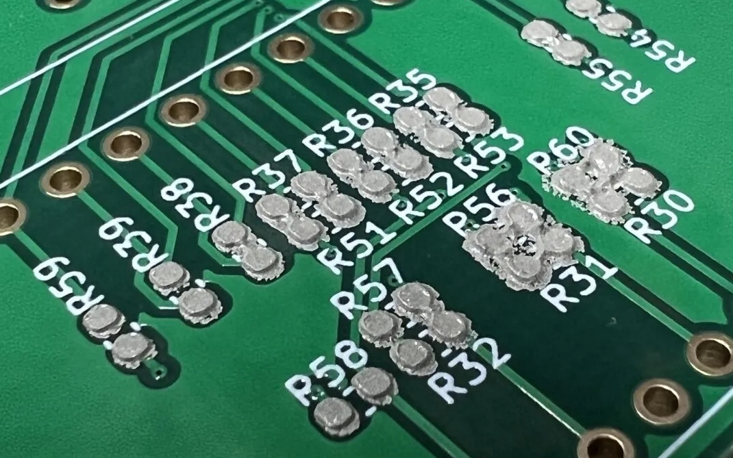 Close-up of solder paste applied to PCB pads using a stencil.