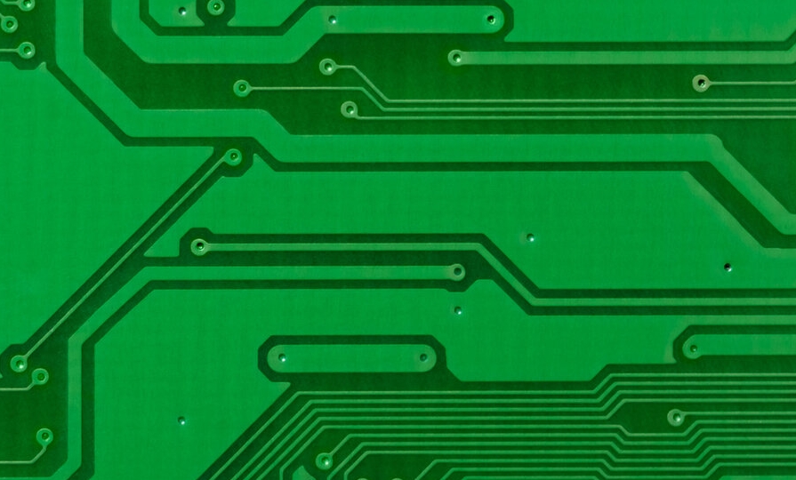 Close-up of PCB with laser-drilled micro-vias showcasing precision.
