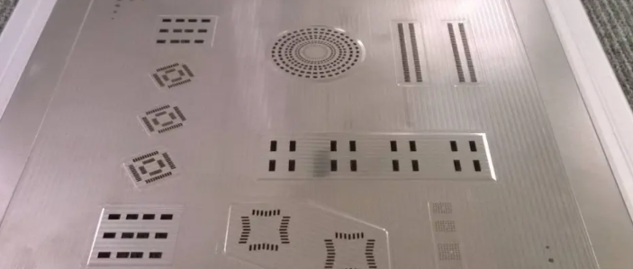 Close-up of an SMT stencil with precise laser-cut openings for solder paste application