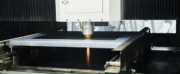 "Laser cutting machine creating precise apertures in an SMT stencil for high-precision assembly."