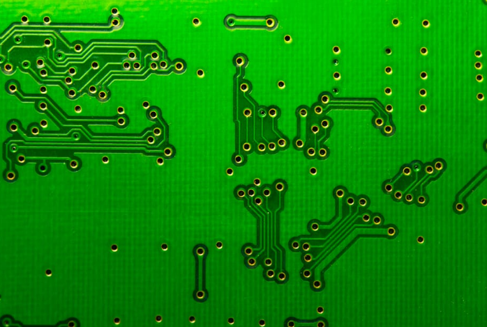 "Illustration of desmearing process on a laser-drilled PCB hole for improved cleanliness."