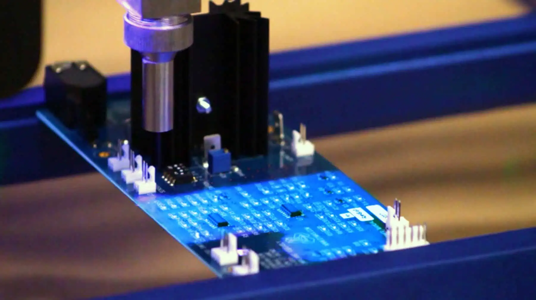 Space probe PCB with conformal coating fluorescing under UV light for protection in extreme environments