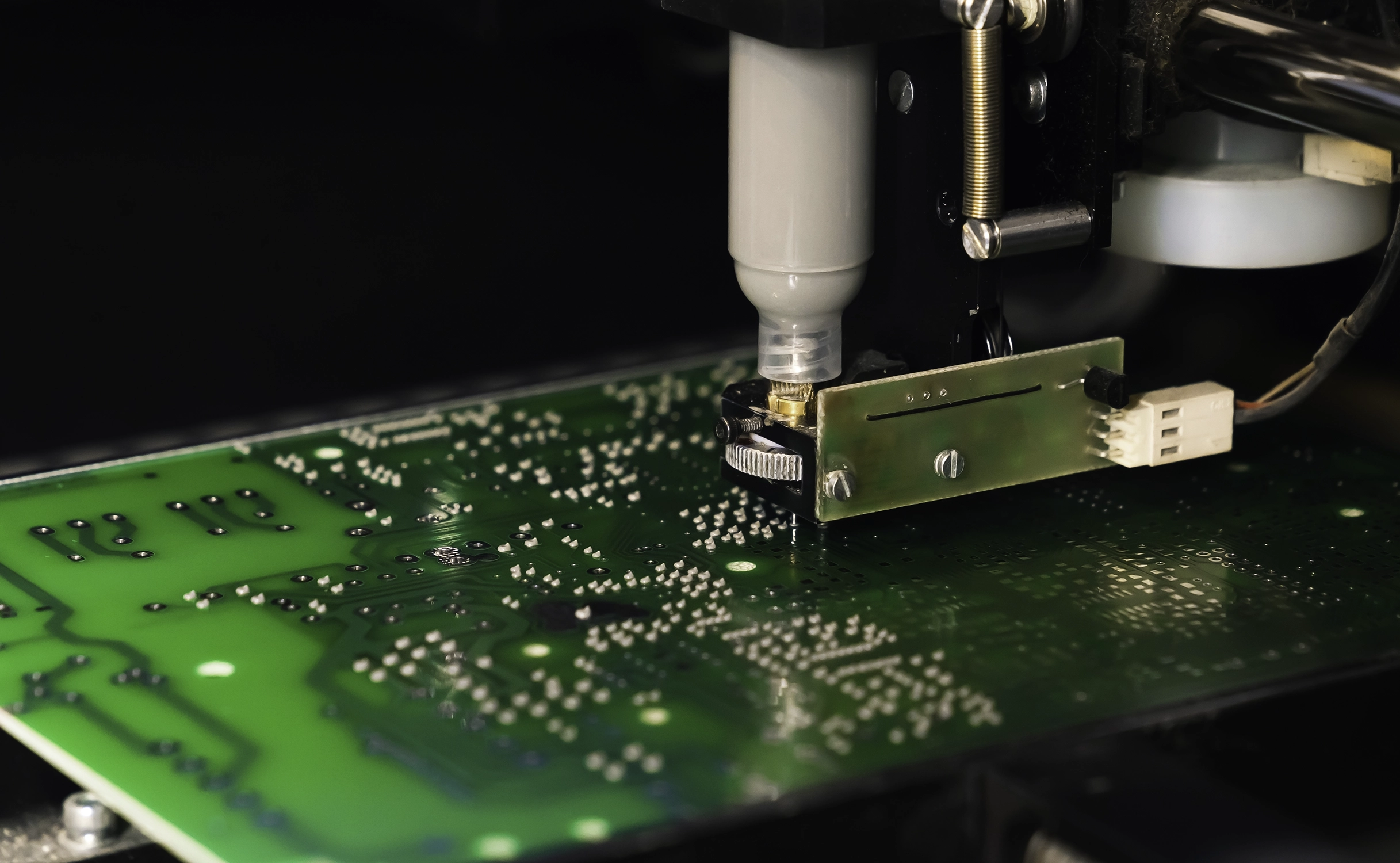 Solder paste printer applying paste on PCB during SMT assembly