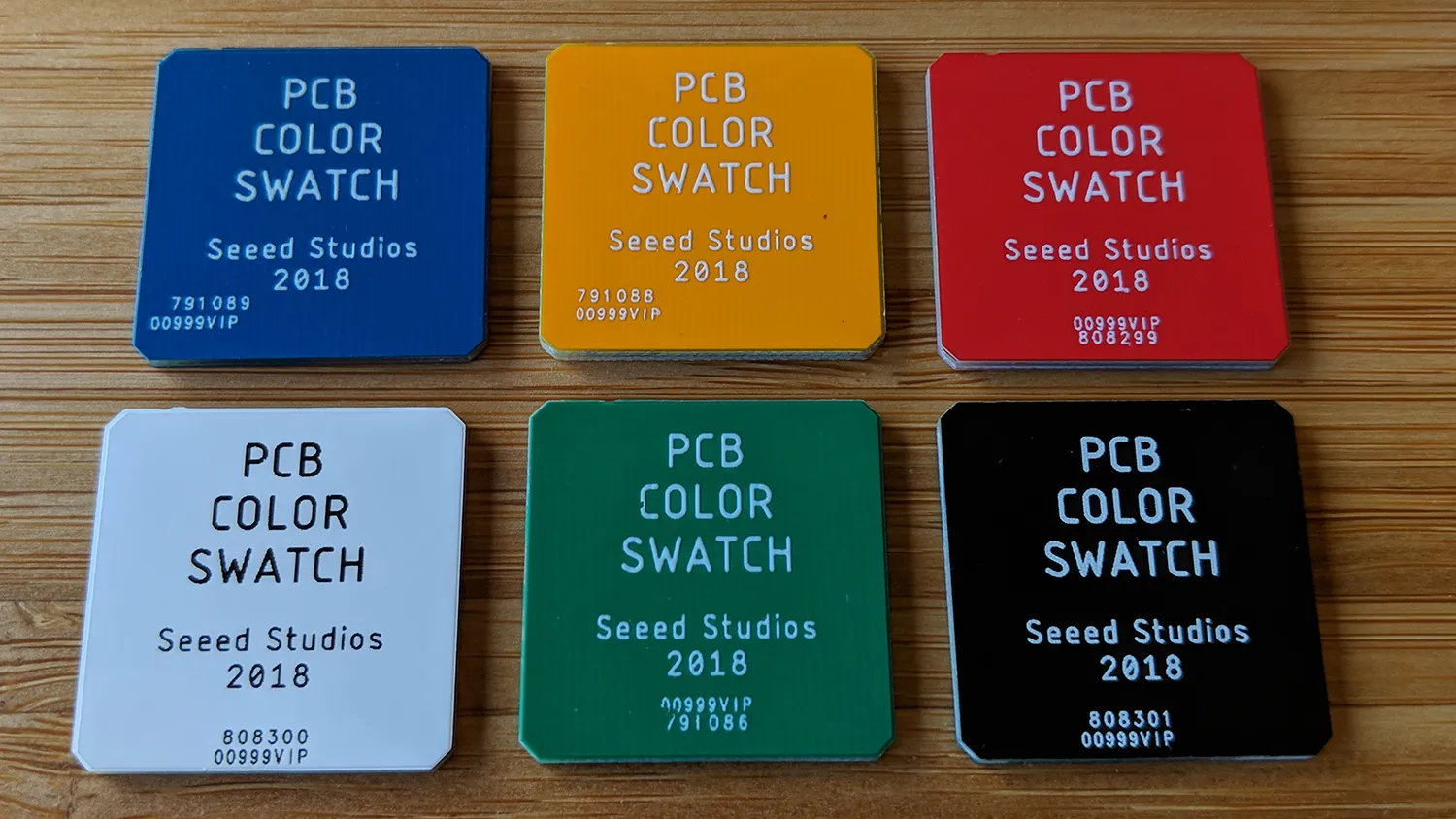 PCB silkscreen ink colors on different solder mask backgrounds.