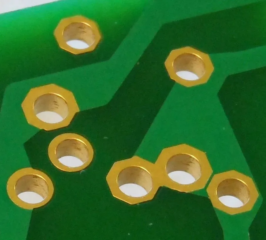 Cross-section of a PCB showing a plated through-hole with copper plating