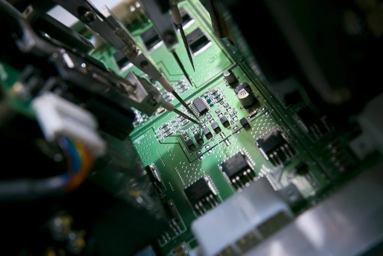 Close-up of SMT assembly on a microelectronics PCB with miniature components