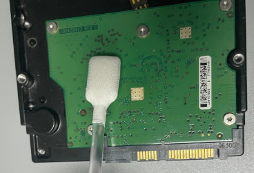 Manual PCB cleaning with isopropyl alcohol and brush after rework