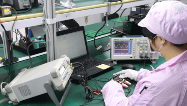 Technician reviewing burn-in testing data for electronic components