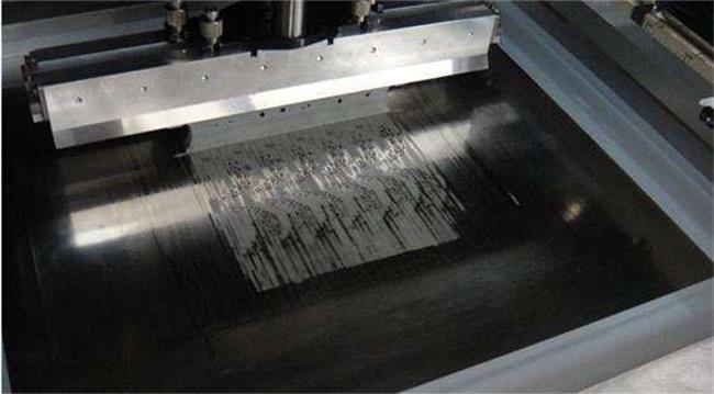 Mounted stencil applying solder paste for SMT in mixed technology PCB assembly.