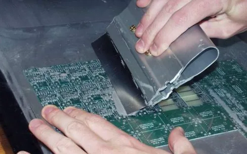 SMT stencil on PCB with solder paste application.