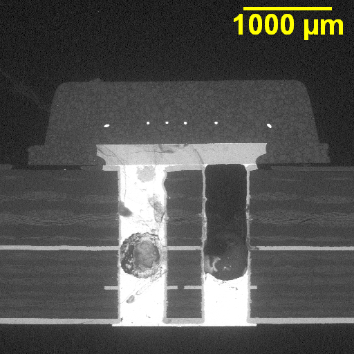 Microscopic view of via cracking in a PCB due to thermal stress.