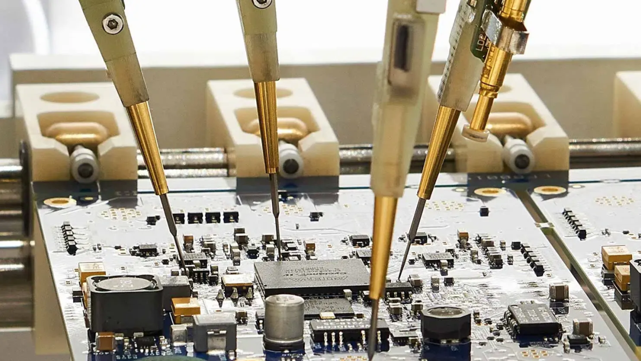 Close-up of SMT test points on a PCB with a test probe