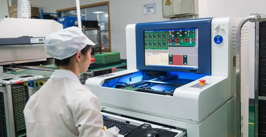 Technician analyzing AOI inspection results for PCB defects.