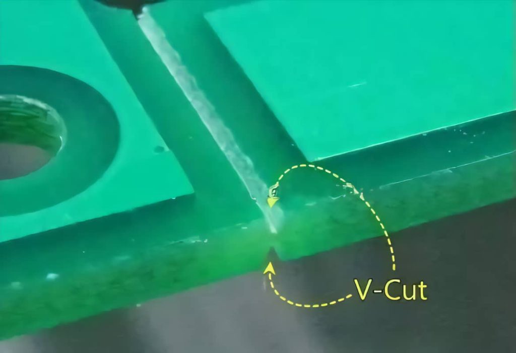 Close-up of V-Score grooves on a PCB panel for depaneling.