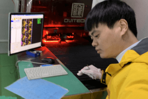 Technician ensuring gold plating quality with precise equipment.