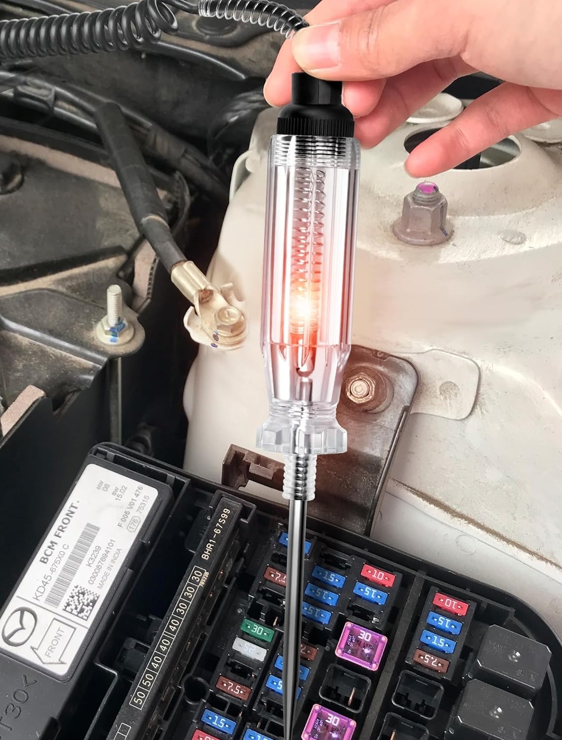 Engineer testing durability of automotive indicator lights.