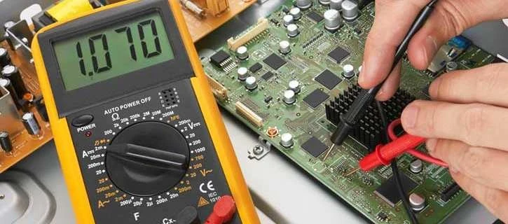 Hobbyist testing continuity on a flex PCB with a multimeter.