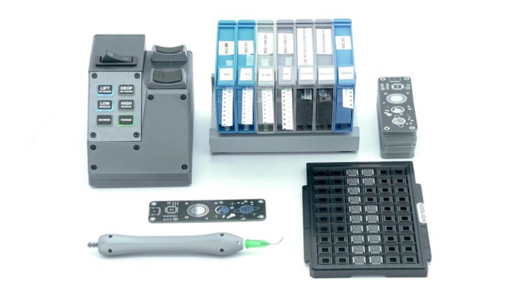 Organized SMT assembly workspace with manual pick and place tools.
