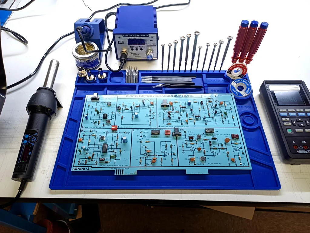 SMD soldering workstation with essential tools like soldering iron and tweezers.