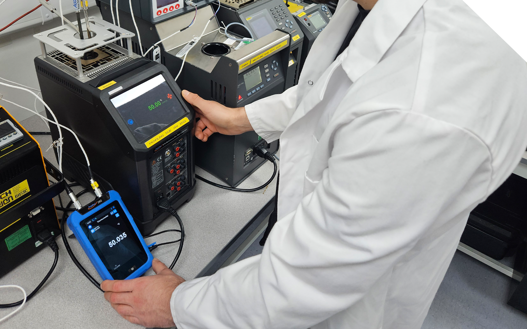 Technician calibrating a thermocouple for thermal profiling accuracy.