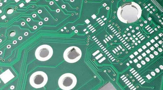 Finished PCB showcasing various drilled hole diameters for components and vias.