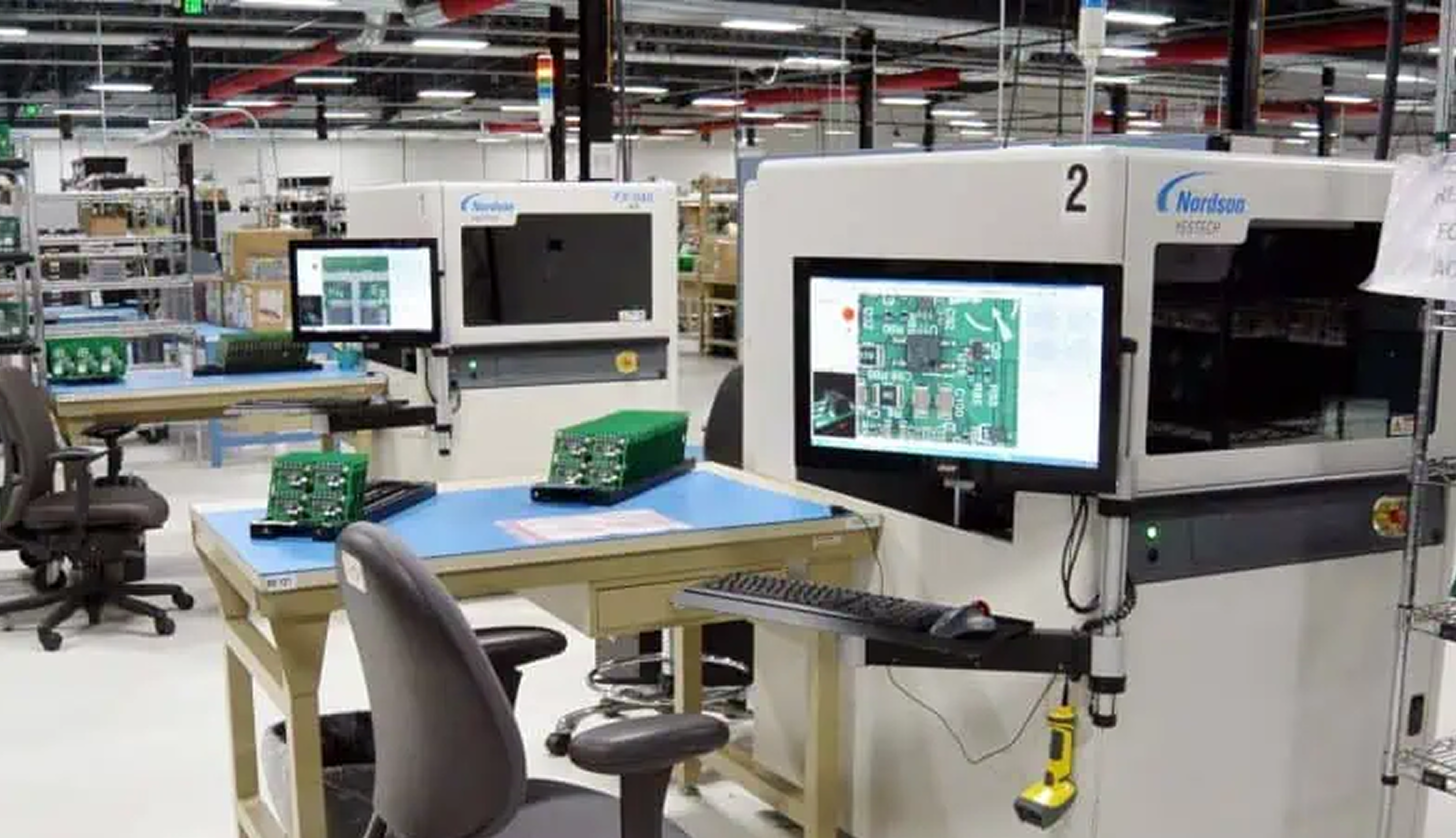 PCB manufacturing line with automated copper thickness testing equipment.