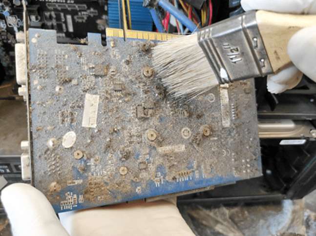 Dirty printed circuit board with flux residue and contaminants.
