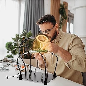 Inspecting soldered joint with helping hands and magnification