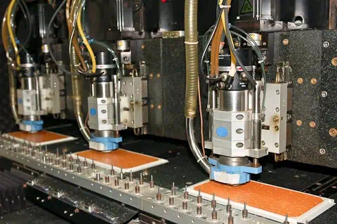 Precision drilling machine performing controlled depth drilling on a PCB.