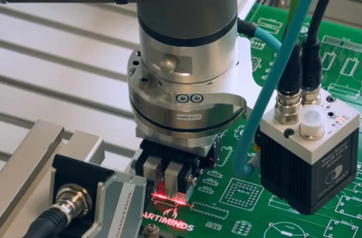Robotic arm in automated PCB handling with ESD protection.