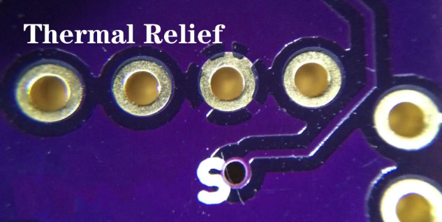 Thermal relief pad design with spoke pattern on PCB.