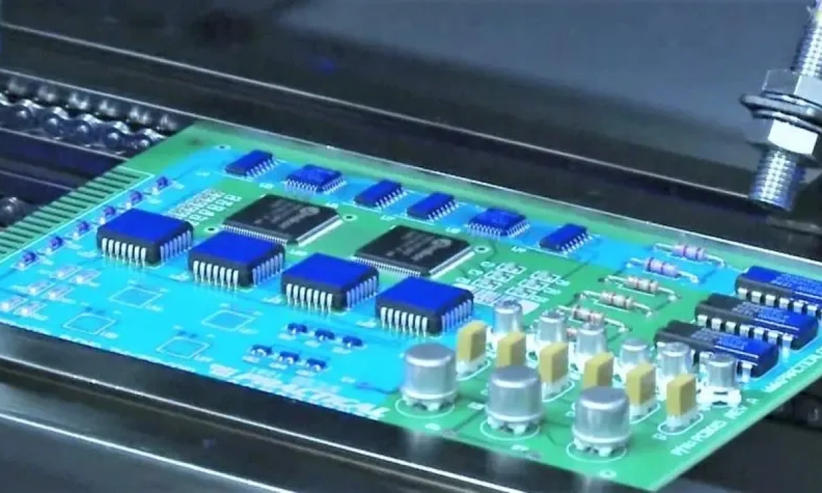 PCB under UV light and a photomask in place
