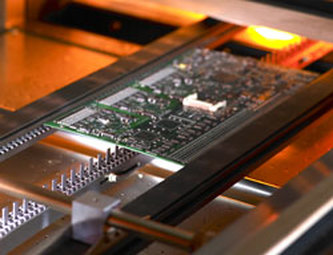 PCB undergoing reflow soldering in a controlled oven environment