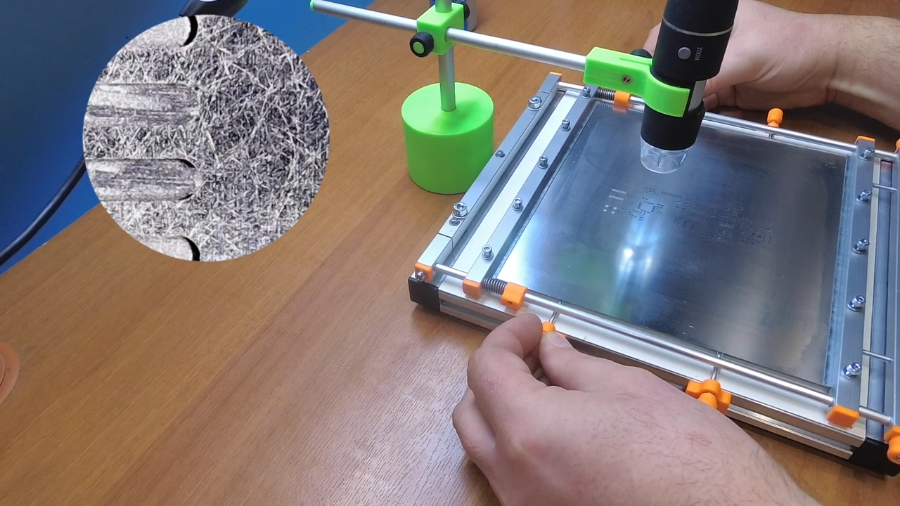 Engineer aligning stencil fiducials over PCB in manual printer