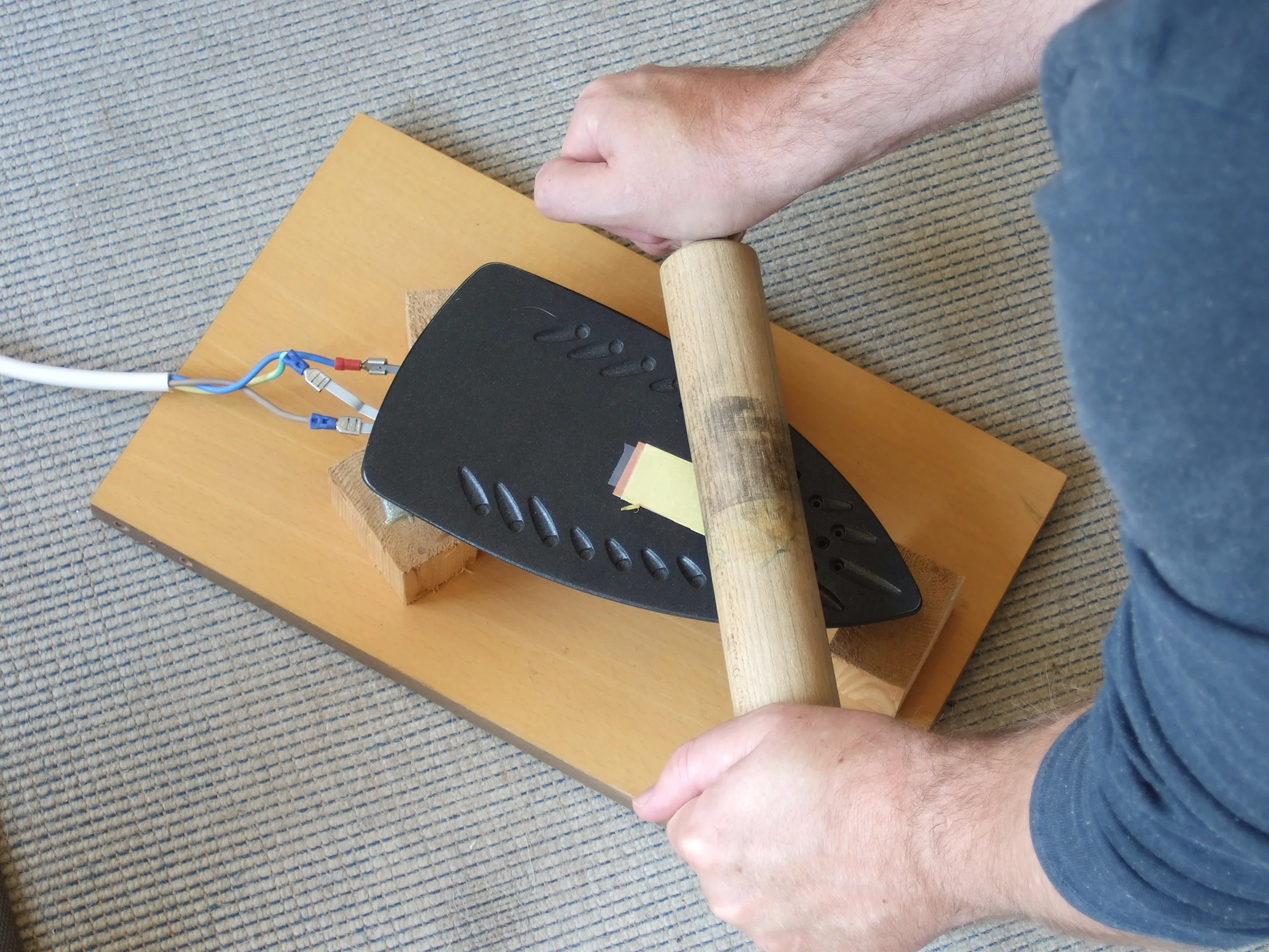 Applying heat and pressure with iron to transfer toner onto PCB copper