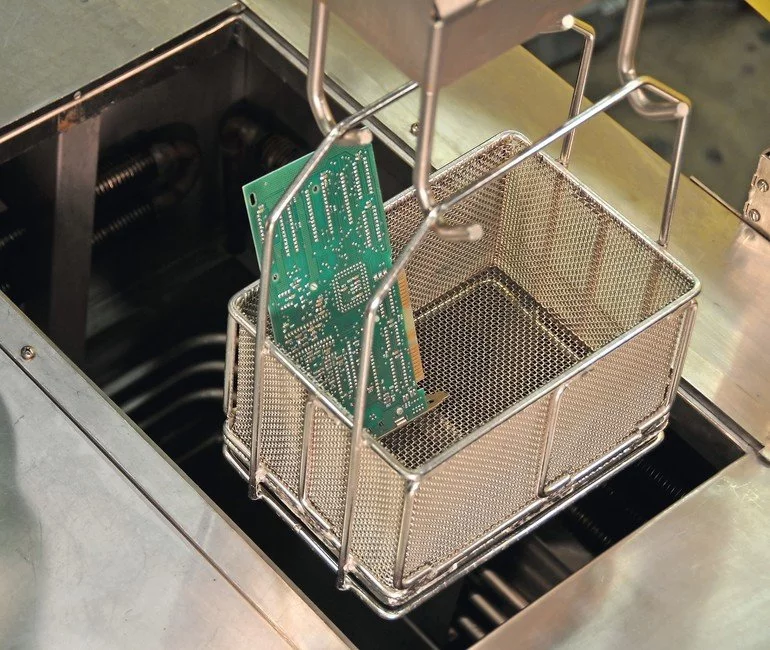 PCB basket in vapor degreaser for aerospace electronics cleaning