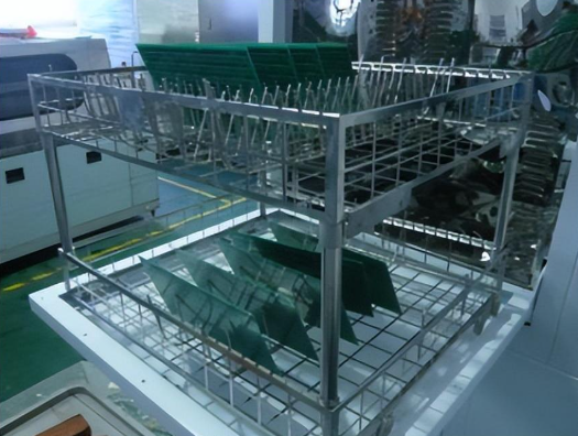 Assembled PCB board entering a cleaning machine conveyor