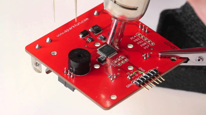 'Fume extraction system positioned over a BGA rework station during component removal'