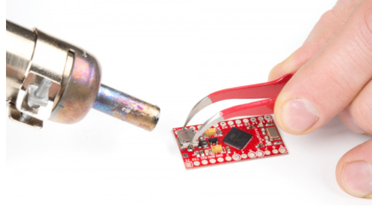 Overview of a PCB rework station with hot air tool and soldering iron