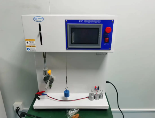 Laboratory equipment performing repeated bend testing on a flexible PCB sample