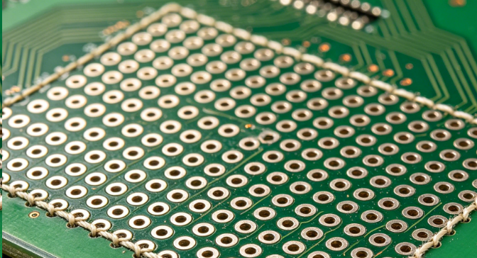 Top view of PCB showing regular grid of stitching vias connecting ground planes