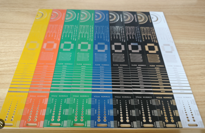 Side-by-side PCBs showing white, black, and yellow silkscreen on different solder masks