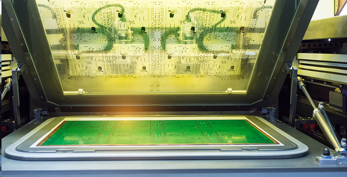UV exposure of liquid photoimageable solder mask through a photomask on PCB