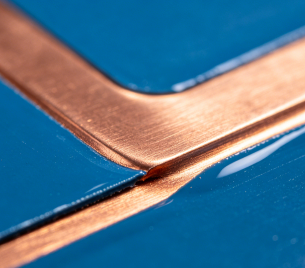 Microscopic view showing blue solder mask thickness and adhesion on copper trace